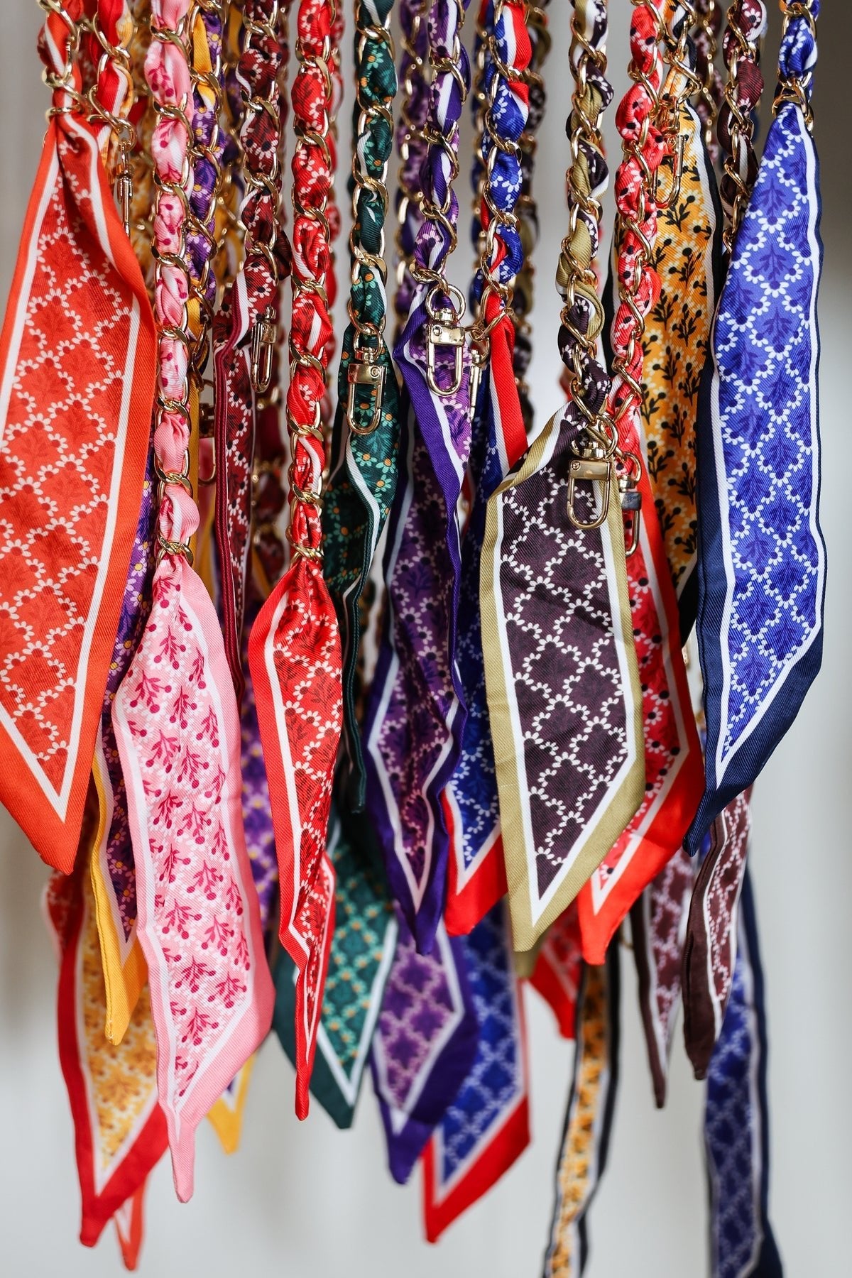 Victory Lap scarf chain strap worn as a phone crossbody