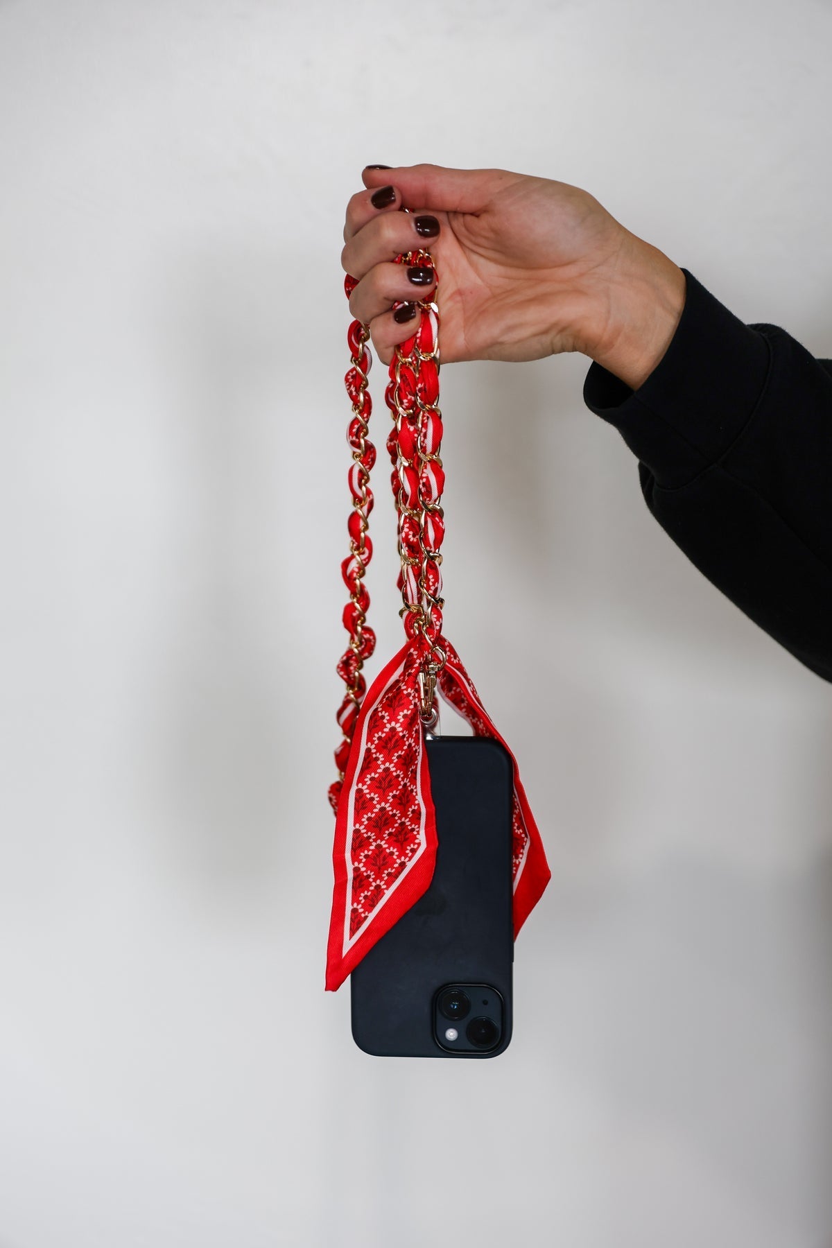 Red scarf chain bag and phone strap, styled